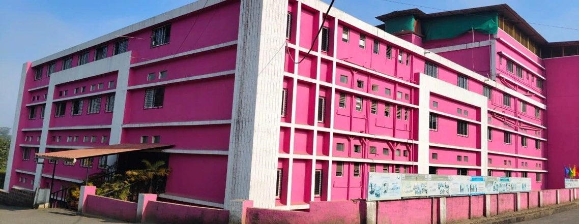 Wide exterior view of the pink and white SSKEMS school building.