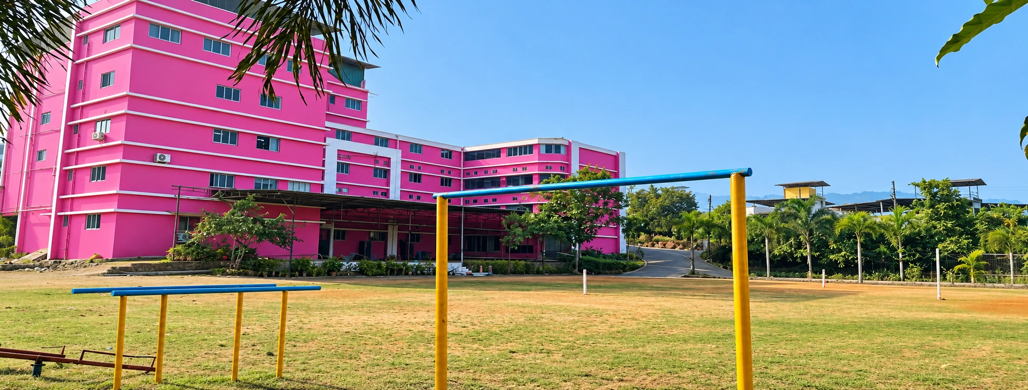 Open school ground with the SSKEMS building visible behind it.